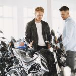 Handsome man choosing a motorcycle to buy
